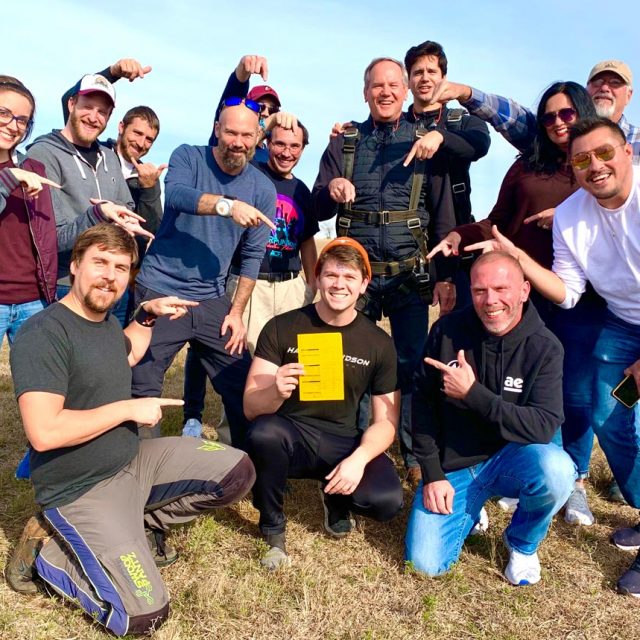 Licensed skydivers and team members at Texas Skydiving celebrate a new skydiver receiving his A-License