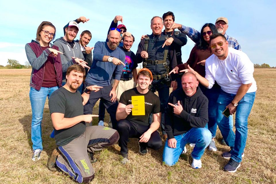 Licensed skydivers and team members at Texas Skydiving celebrate a new skydiver receiving his A-License