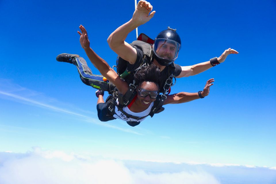 Female student and male instructor in freefall during a tandem skydive at Texas Skydiving near Austin and College Station, TX