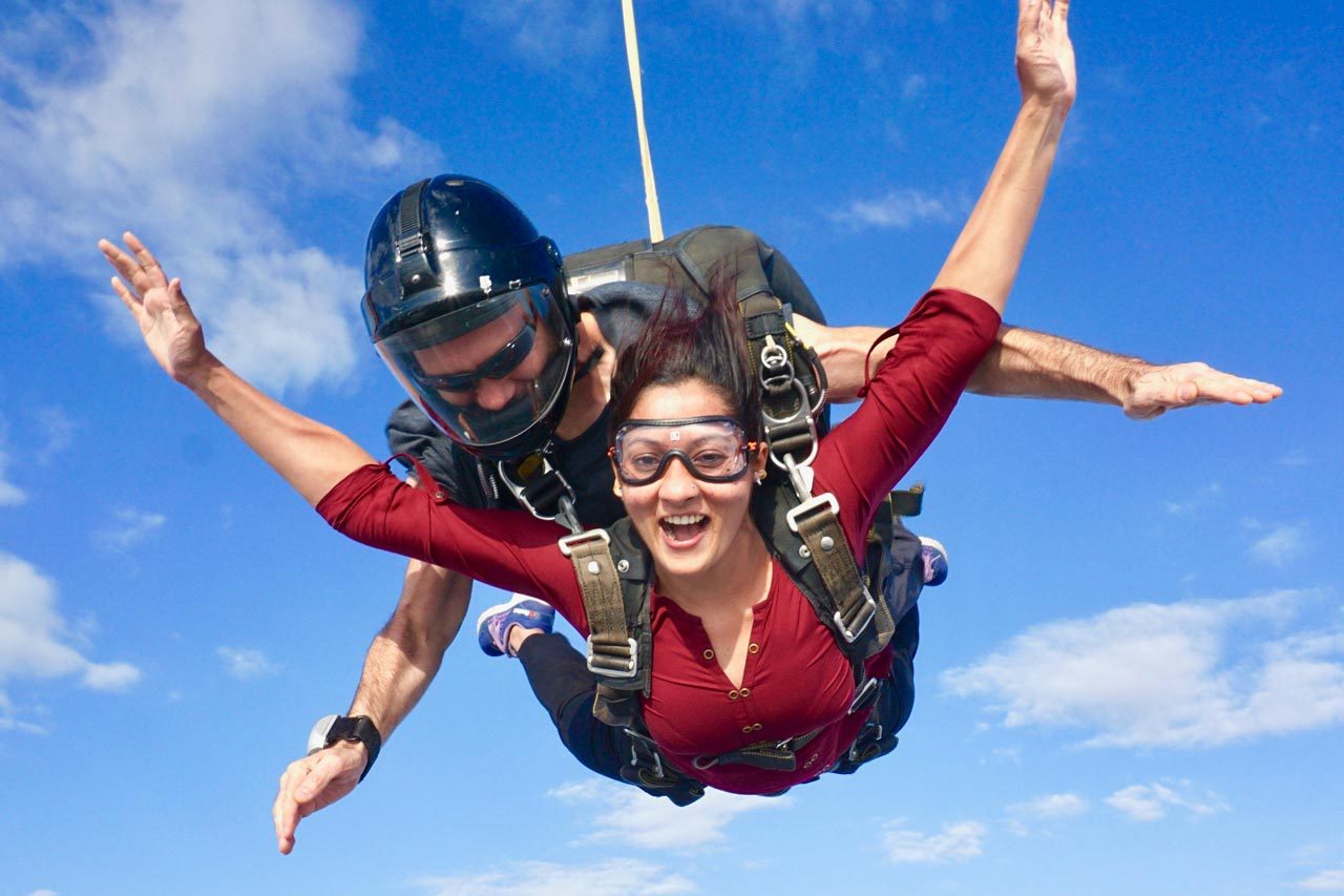 Woman in red shirt tandem skydiving at Texas Skydiving near Austin and College Station, TX