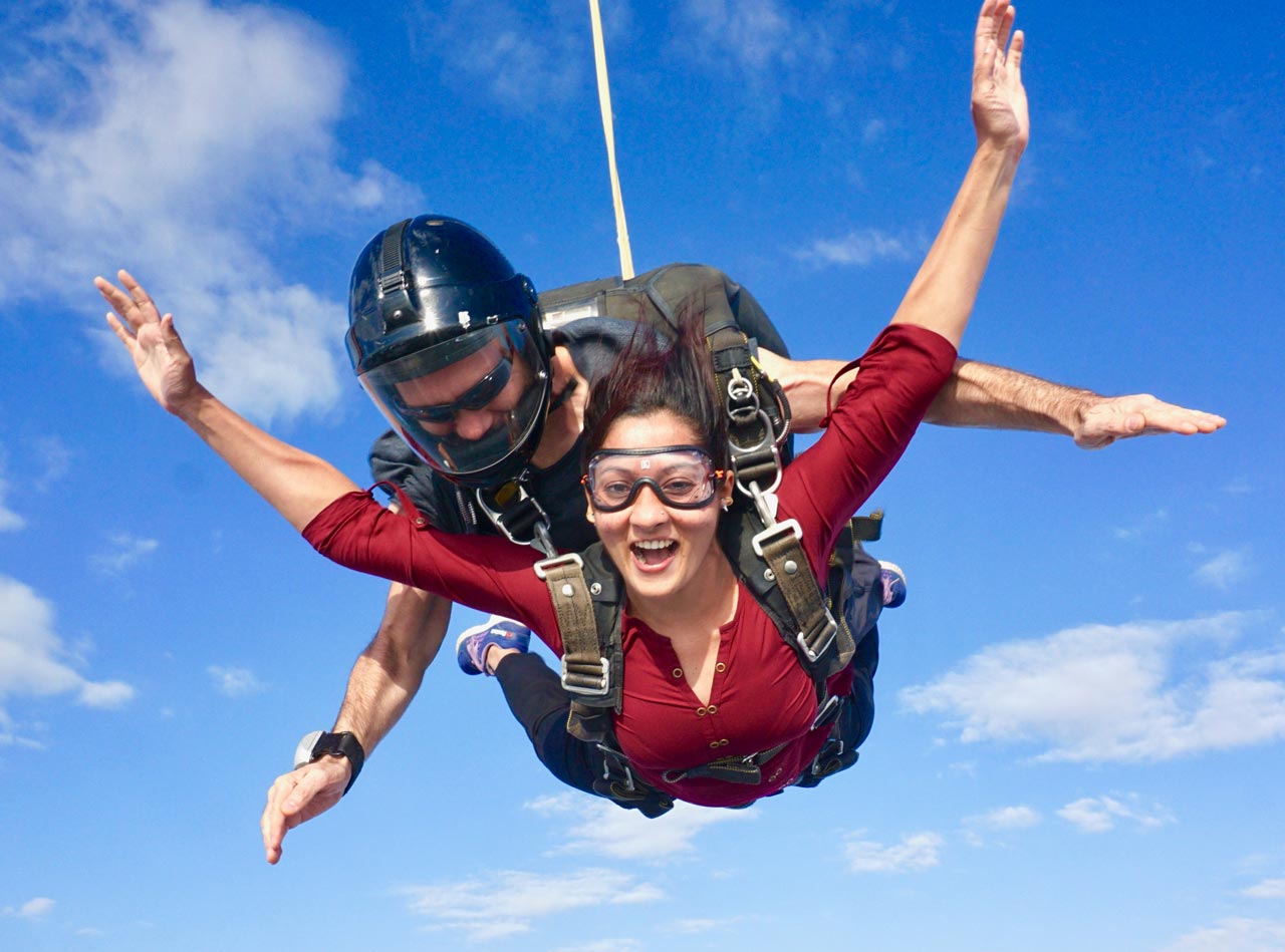 Woman in red shirt tandem skydiving at Texas Skydiving