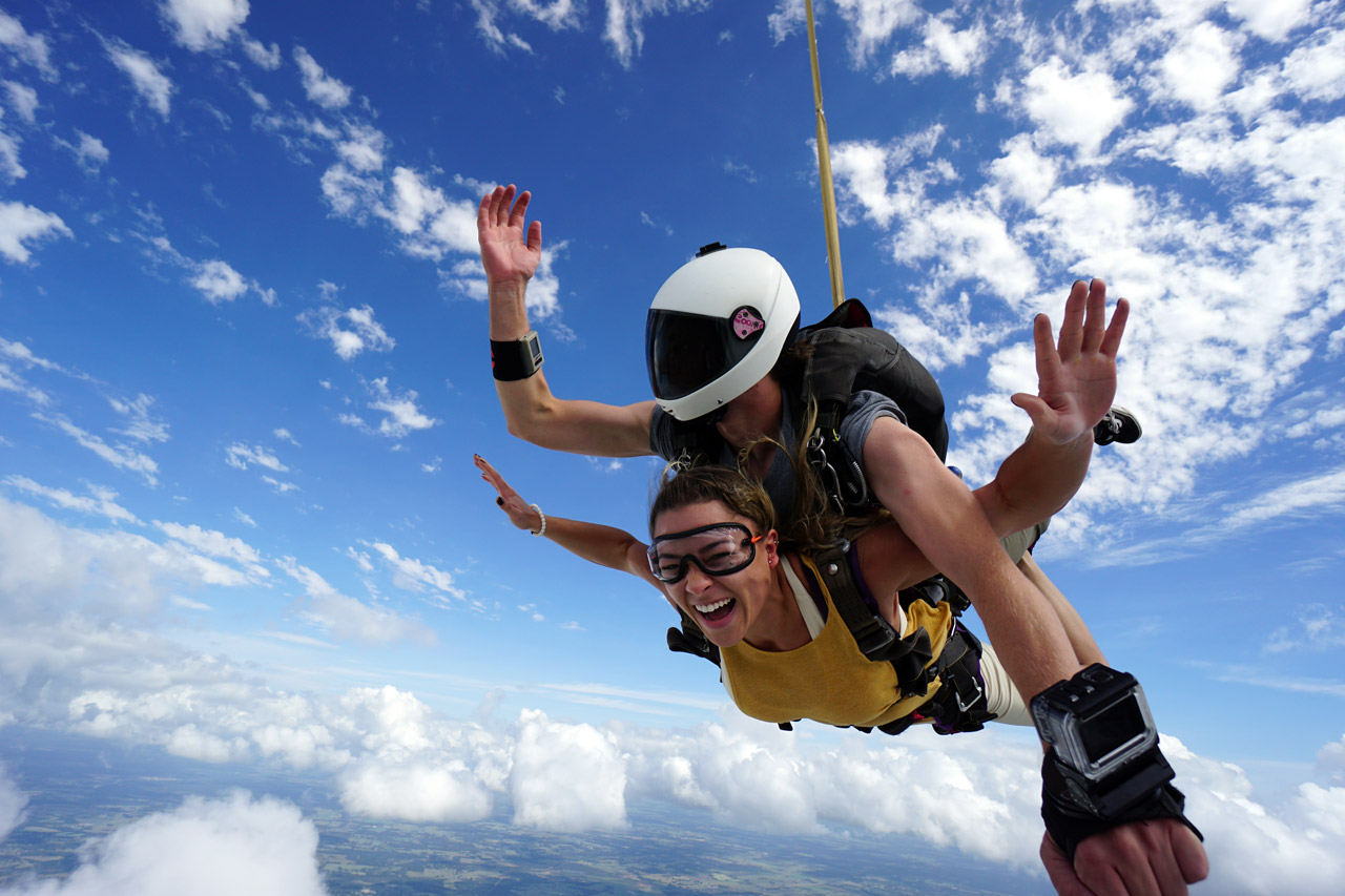 Female in yellow t-shirt enjoying her first time skydiving tandem at Texas Skydiving near Austin, TX