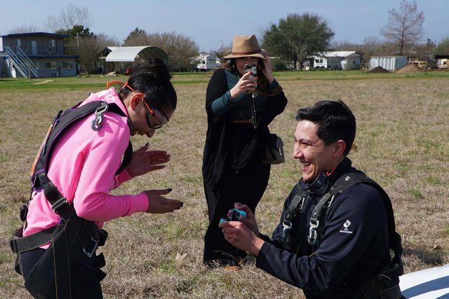 Young man proposing to his girlfriend after skydiving at Texas Skydiving near Austin, TX