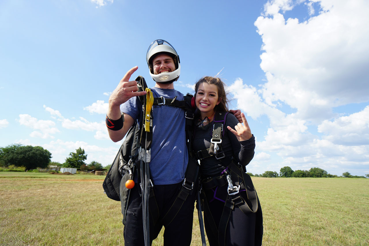 Tandem instructor and student smiling at camera after a tandem skydive at Texas Skydiving 